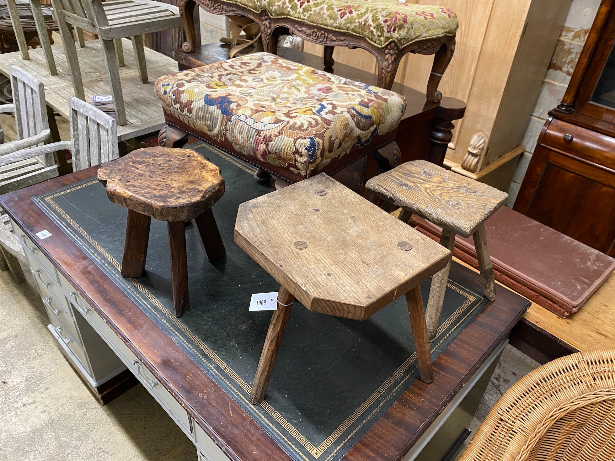 A George I style mahogany tapestry top dressing stool and three rustic stools